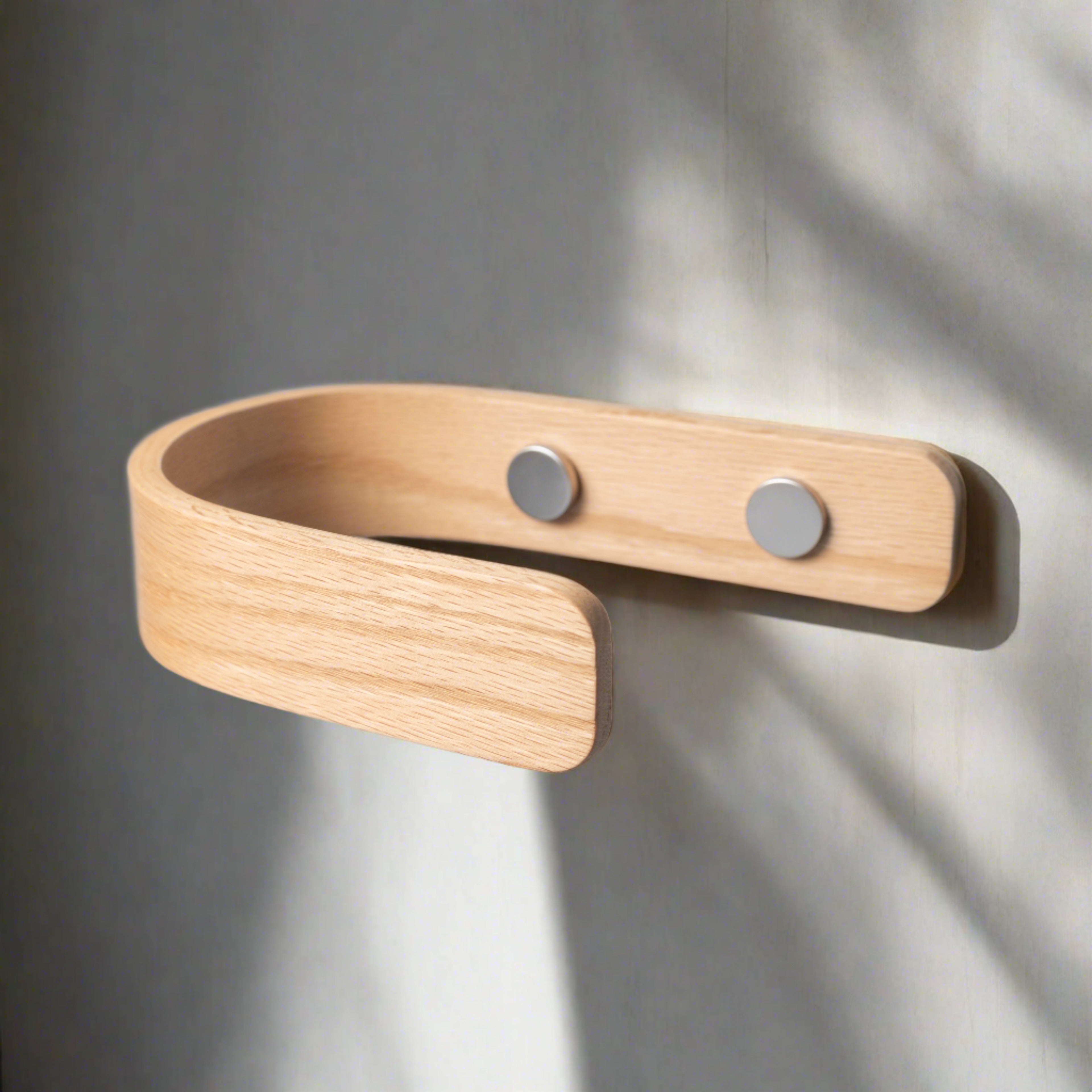 Oak curtain holdback placed on the wall at the correct height with chrome fittings — NOIR.DESIGN