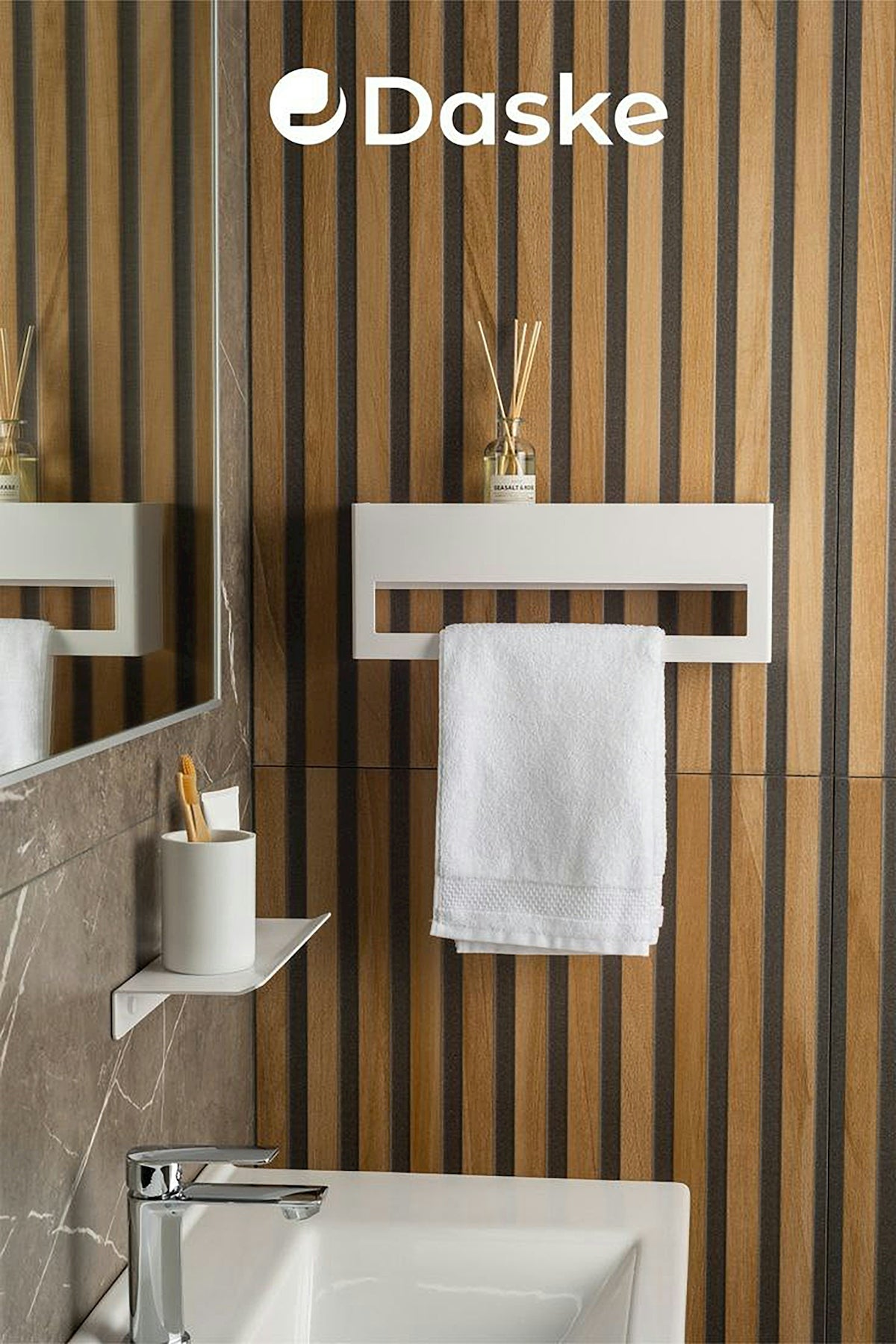 A bathroom with a sink, toilet, and towel rack