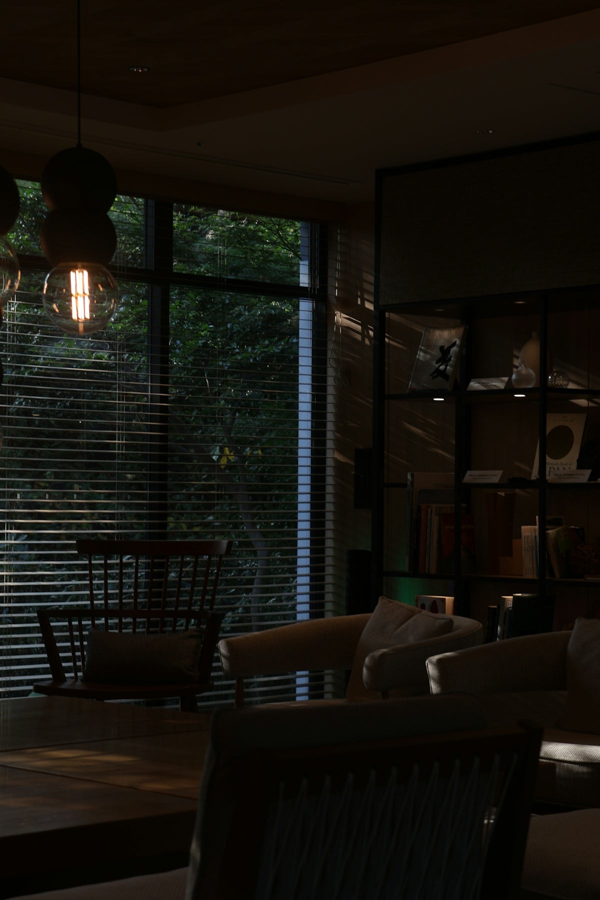 Dimly lit room with chairs and window view
