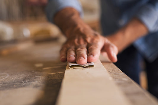 noir.design worker hand sanding a board getting it ready for bending wood