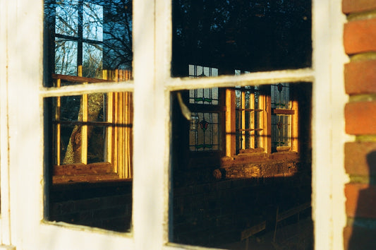 the reflection of a building through a window