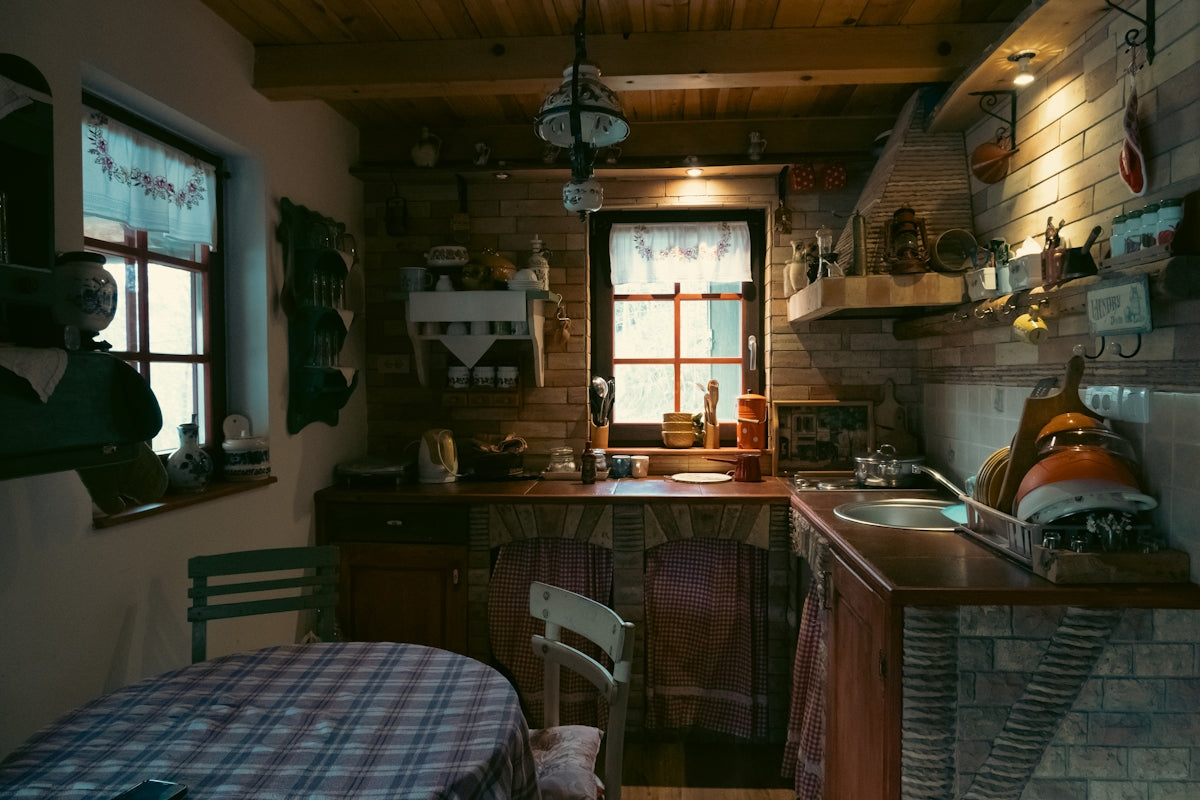 Rustic kitchen with checkered tablecloth and brick walls