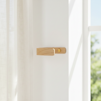 Wooden Curtain holdback on a white wall with a blurred green outdoor background through the window