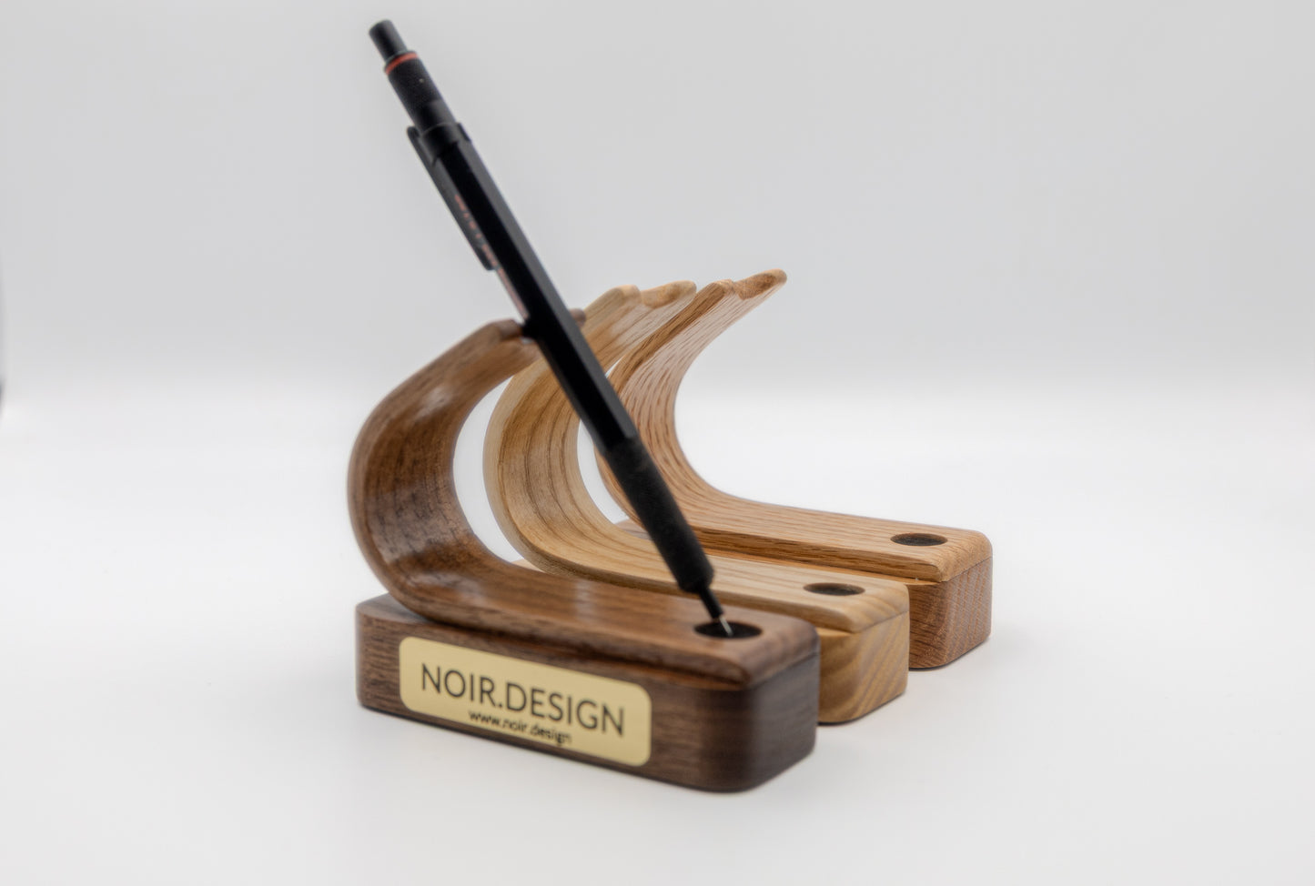 Close-up of engraved brass nameplate on pen stand