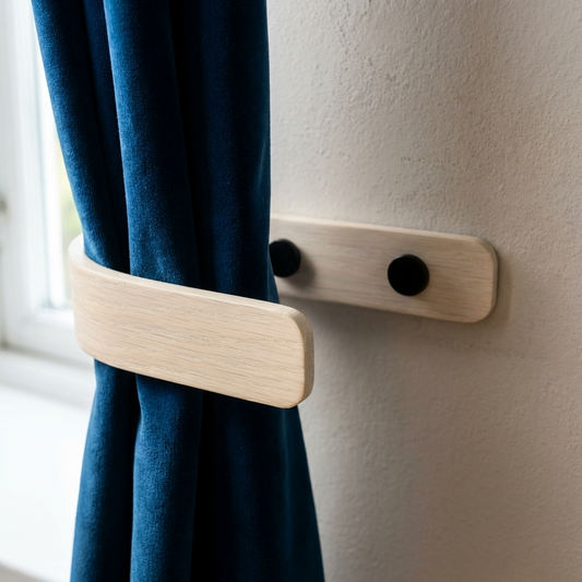 Wooden curtain holder holding a blue curtain against a white wall.